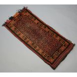 An Afghan saddle bag formed of 14 squares with multi row border 120cm x 57cm