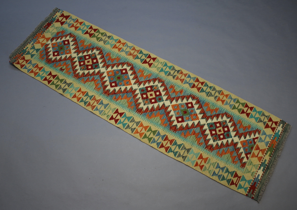 A yellow, turquoise and brown ground Chobi Kilim runner 197cm x 61cm