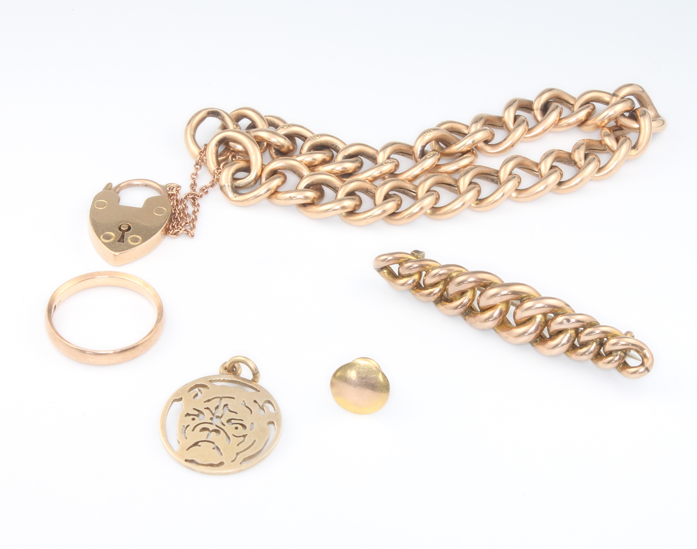 A 9ct yellow gold bracelet and padlock, a ditto stud and ring, 17.5 grams and a yellow metal brooch