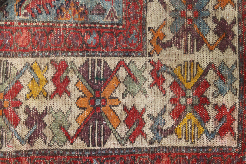 A North West Persian red and blue ground rug with shaped medallion to the centre within a multi - Image 5 of 5