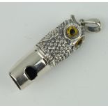 A sterling silver repousse owl whistle with glass eyes 4cm