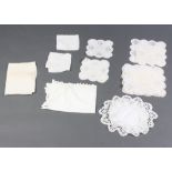 A collection of 19th Century table linens, napkins, doilies in a white plastic crate