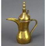 A Turkish brass coffee pot with signature mark to sides, 23cm h x 8cm