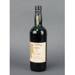 A 1954 bottle of Blandy's Bual Madeira The Madeira is slightly low in the neck, the label is stained