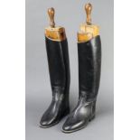 A pair of black leather riding boots size 7 together with a pair of Faulkner & Sons beech boot