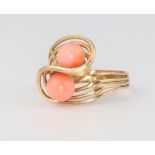 A 14ct yellow gold carved coral crossover ring, size M, 4.2 grams