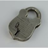 A white metal padlock and key inscribed 1926 8.5cm