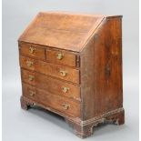 A Georgian light oak bureau with fall front above 2 short and 3 long drawers with replacement