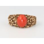 A 9ct yellow gold cabochon coral ring, size M, 6.8 grams