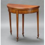 An Edwardian Georgian style mahogany demi-lune card table raised on square tapered supports, spade