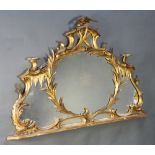A 19th Century Chippendale style plate over mantel mirror contained in a carved gilt wood frame