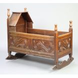 A 17th/18th Century style carved oak rocking crib formed of old timber 84cm h x 61cm w x 95cm l