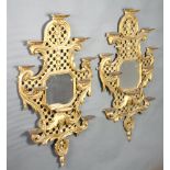 A pair of 19th Century Chippendale style octagonal plate mirrors contained in pierced gilt carved