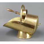 A brass helmet shaped coal scuttle complete with shovel 30cm h x 48cm x 28cm