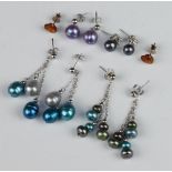 Four pairs of silver cultured pearl earrings together with a pair of amberoid ditto