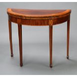 A Georgian inlaid and crossbanded mahogany demi-lune tea table, raised on square tapered supports,