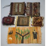 Four Persian carpet cushions 48cm x 38cm, 38cm x 42cm, 31cm x 25cm and 29cm x 27cm