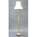 A silver painted Italian style turned and fluted standard lamp, raised on a circular base with paw