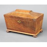 A Georgian bleached mahogany tea caddy of sarcophagus form with hinged lid, raised on bun feet