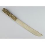 A Meiji period carved ivory paper knife the reticulated handle enclosing figures 40cm There are