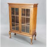 A 1930's mahogany display cabinet with moulded cornice, fitted shelves enclosed by astragal glazed