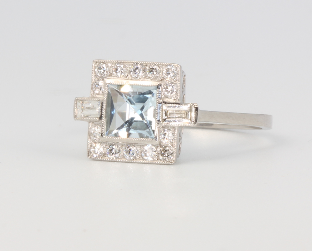 A platinum Art Deco style aquamarine and diamond ring, the centre stone approx. 0.75ct surrounded by