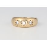 A gentleman's 9ct yellow gold 3 stone diamond gypsy ring, 5.2 grams, 0.35ct, size M 1/2