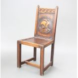 A 1920's carved oak hall chair with solid back carved a galleon, raised on square supports 96cm h