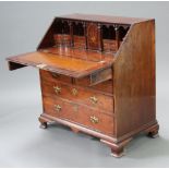 A Georgian mahogany bureau, the fall front revealing a well fitted interior with pigeons holes,