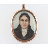 A 19th Century oval miniature portrait of a young gentleman contained in a gilt pendant 5cm x 3cm
