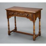 An Ipswich style carved oak side table fitted a frieze drawer, raised on turned and block supports