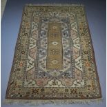 A Caucasian style brown and blue ground rug with central medallion within a multi-row border 297cm x