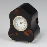 An Edwardian tortoiseshell dome topped timepiece raised on bun feet 10cm