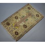 A Caucasian style green, white and brown ground rug with rectangular central medallion 139cm x 91cm
