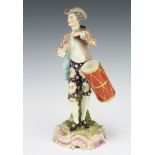 A Samson 19th Century figure of a standing gentleman carrying a drum, raised on a rococo base 30cm