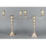 A pair of silver plated 3 light candelabra on tapered stems 38cm
