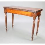 A Georgian mahogany D shaped tea table raised on turned supports 74cm h x 96cm w x 42cm d The top is