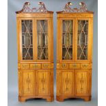 A handsome pair of 20th Century Hepplewhite style painted satinwood corner cabinets with pierced and