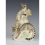 A porcelain group of 2 ocelots amongst flowers, signed Phyllida 22cm 1 tail is chipped and there are