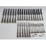 Twelve silver plated lily pattern butter knives, 6 pairs of ditto plated dessert eaters and 12 ditto