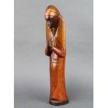 An African carved hardwood figure of a standing figure in prayer 47cm x 8cm x 9cm
