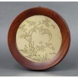 A circular Japanese polished gilt metal plaque depicting tree, serpent and bird 18cm, with seal mark