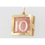 A 9ct yellow gold 10 shilling note charm