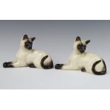 Two Royal Doulton figures of reclining Siamese cats no.1558 18cm