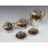 A 1920's Japanese porcelain coffee set decorated with views of Mount Fuji comprising coffee pot, 2