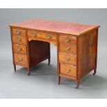 A Victorian mahogany kneehole desk with red inset writing surface above 1 long and 8 short drawers