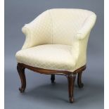 An Edwardian tub back armchair upholstered in white material, raised on cabriole supports 79cm h x