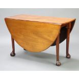 A 19th Century oval drop flap pad foot dining table raised on cabriole, ball and claw supports