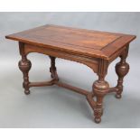 An 18th Century style Dutch oak centre table with ebony stringing, raised on cup and cover