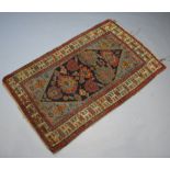 A North West Persian red and blue ground rug with shaped medallion to the centre within a multi